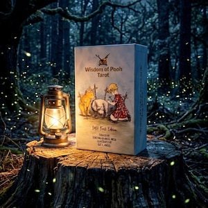 May include: A rectangular box titled Wisdom of Pooh Tarot with an illustration of a bear and a child, accompanied by a lit metal lantern. The box text includes 2013 Fouss Edition, created by Ssaefinca & Angel Mesa, and illustrated by Kat L. Ansel.