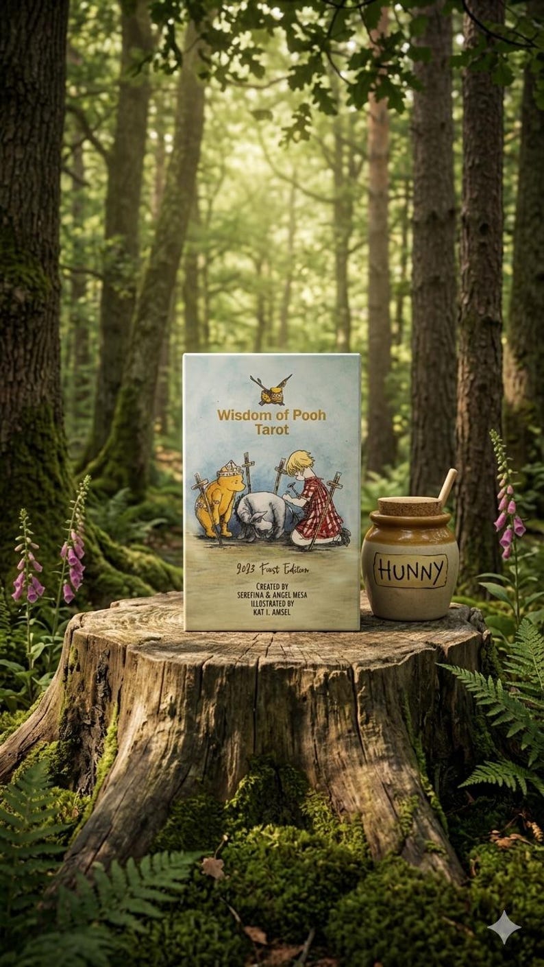 May include: A rectangular Wisdom of Pooh Tarot deck box featuring a watercolor illustration of characters with swords, alongside a small ceramic honey pot labeled HUNNY with a wooden dipper. The box text reads 2023 First Edition, Serefina & Angel Mesa.