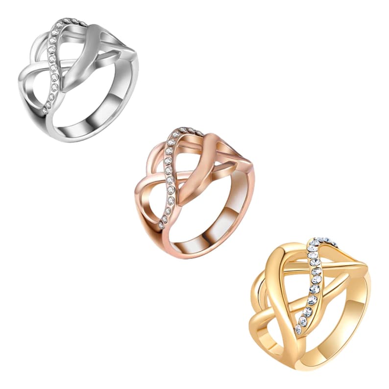 Puede incluir: Tres anillos en plata, oro rosa y oro. Cada anillo presenta un dise&ntilde;o de s&iacute;mbolo de infinito con una fila de peque&ntilde;as piedras preciosas transparentes. Los anillos se muestran sobre un fondo blanco.