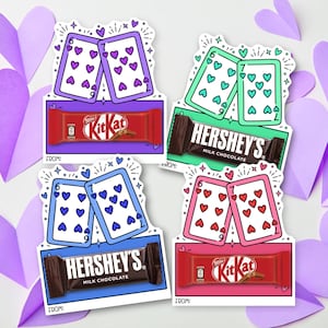May include: Four Valentine's Day-themed gift tags featuring playing cards with heart suit symbols and chocolate bars. The tags have a Kit Kat bar and a Hershey's bar. The cards are in purple, green, blue, and pink.