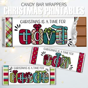 May include: Candy bar wrappers with Christmas-themed designs. The wrappers feature gift box illustrations spelling out "LOVE", "JOY", and "PEACE" with the phrase "Christmas is a time for". The wrappers have a white background with colorful accents.