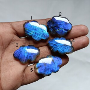 May include: Five iridescent blue labradorite gemstone cabochons in a cloud shape.