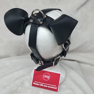 May include: Black leather dog mask with silver hardware and two floppy ears. The mask is on a white mannequin head. The text on the card reads "DAM Thank you for your purchase from Dotty After Midnight Happy with your purchase?"