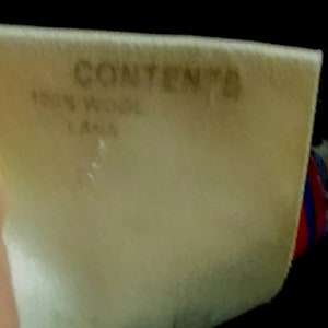 May include: A white tag with the word "CONTENT" printed in black. The tag also has the text "150N WIDE" and "L444" printed in black.
