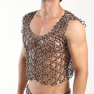 May include: A black and silver chainmail vest with a scoop neck.