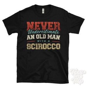 May include: Black t-shirt with a vintage-style graphic that reads "Never underestimate an old man with a Scirocco".