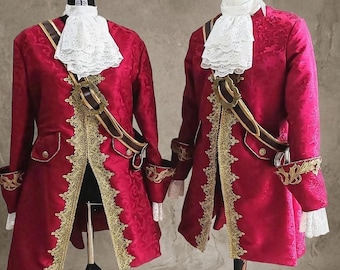May include: Two matching deep red coats with intricate tonal floral patterns, gold lace trim along the front edges and cuffs, and white lace jabots at the neck. Each coat features a brown and gold decorative sash worn across the chest.