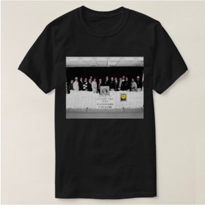 May include: A black and white photograph of a group of people standing in front of a wall of white bricks. The people are wearing suits and ties, and they are all looking at the camera. The wall is covered in white bricks, and there is a sign on the wall that reads "NYC GROUP 742 1494 KILOGRAMS COCAINE".