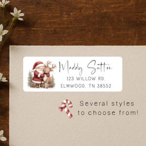 May include: A rectangular label with a Christmas theme. The label features an illustration of Santa Claus and a reindeer. The text on the label reads "Maddy Sutter, 123 Willow Rd. Elmwood, TN 38552." A candy cane graphic and the text "Several styles to choose from!" are also present.