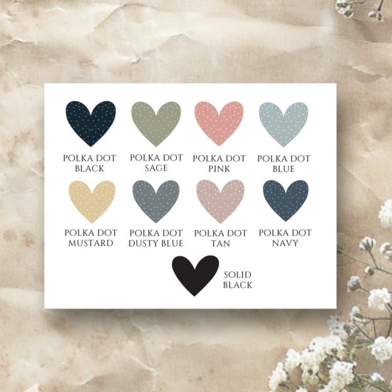 May include: A chart with ten heart-shaped color swatches. The swatches are labeled with the color names: Polka Dot Black, Polka Dot Sage, Polka Dot Pink, Polka Dot Blue, Polka Dot Mustard, Polka Dot Dusty Blue, Polka Dot Tan, Polka Dot Navy, and Solid Black.