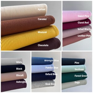 May include: A collection of ribbed fabric swatches in various colors, including apricot, caramel, mustard, chocolate, sweet pink, claret red, velvet mocha, leather pink, white, black, biscuit, aubergine, midnight blue, powder blue, oxford blue, dove grey, pine, seafoam, forest green, and sage.