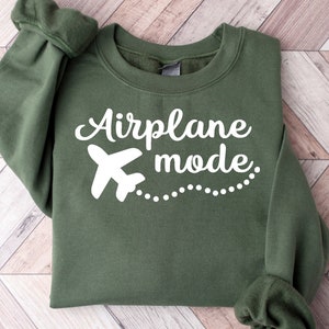 May include: A green sweatshirt with the text "Airplane mode" in white lettering and a white airplane graphic.