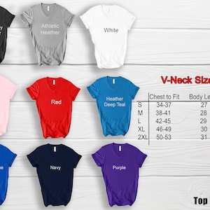 May include: A selection of V-neck t-shirts in various colours: dark grey, athletic heather, white, pink, red, heather deep teal, royal blue, navy, and purple. A size chart is also displayed.