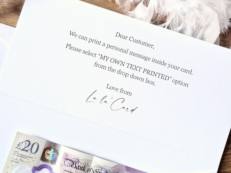 Op de afbeelding: Een witte kaart met gedrukte tekst, waaronder "Beste klant" en instructies voor een gepersonaliseerde boodschap. De kaart is ondertekend met "Love from La la Card". Een biljet van twintig pond is onderaan zichtbaar.