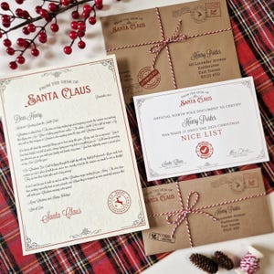May include: Christmas stationery from Santa Claus, including a letter and certificate for Henry, and two envelopes tied with red and white twine. The letter and certificate are decorated with festive borders and stamps.