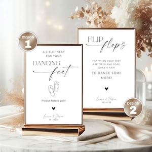 May include: Two rectangular white signs with copper-colored frames, labeled Design 1 and Design 2. Design 1 reads A LITLE TREAT FOR YOUR DANCING feet, Please take a pair!, Laura & Jason, 28 | 09 | 25. Design 2 reads FLIP flops, FOR WHEN YOUR FEET ARE TIRED AND SORE, GRAB A PAIR TO DANCE SOME MORE!, Laura & Jason, 28 | 09 | 25.