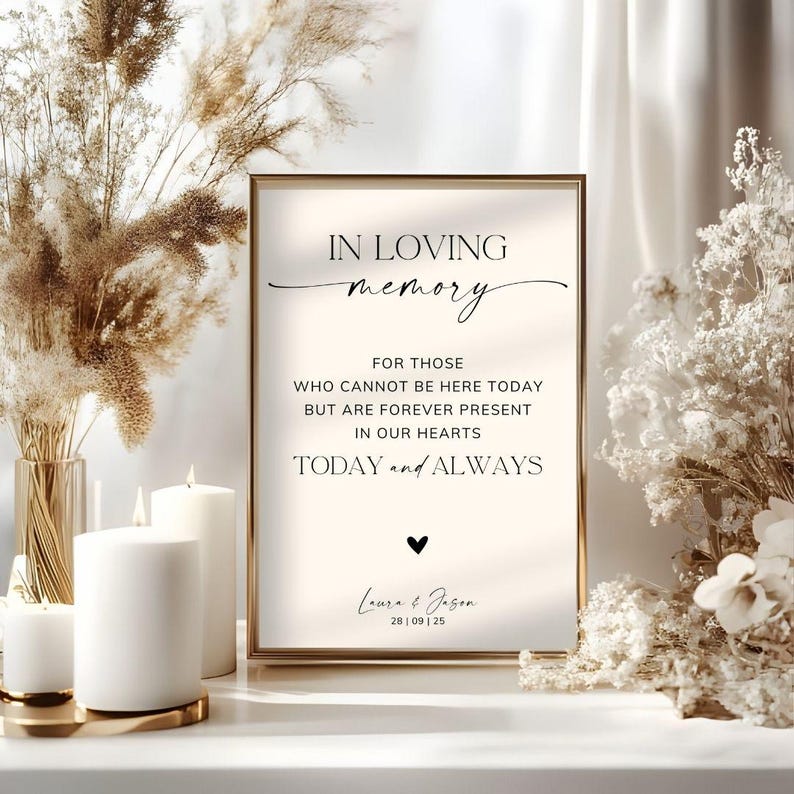 May include: A rectangular sign in a gold frame with the text IN LOVING memory FOR THOSE WHO CANNOT BE HERE TODAY BUT ARE FOREVER PRESENT IN OUR HEARTS TODAY and ALWAYS, a small black heart icon, and the names Laura & Jason with 28 | 09 | 25.