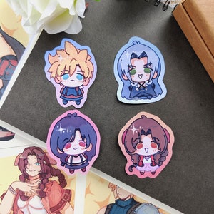 May include: Four colourful cartoon character stickers featuring a blonde character with blue eyes, a blue-haired character with green eyes, a brown-haired character with blue eyes, and a black-haired character with blue eyes.