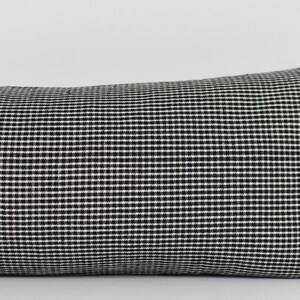 May include: Black and white gingham lumbar pillow. The pillow is made of a soft, woven fabric with a subtle sheen.