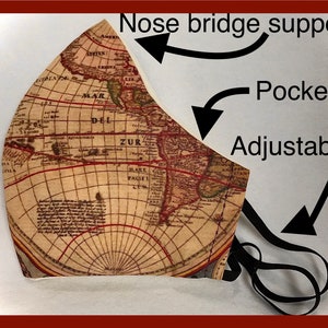 May include: A face mask with a vintage map design. Features include nose bridge support, a pocket, and adjustable ear loops. The mask is primarily beige with a detailed map print in shades of brown and red, and black elastic ear loops.
