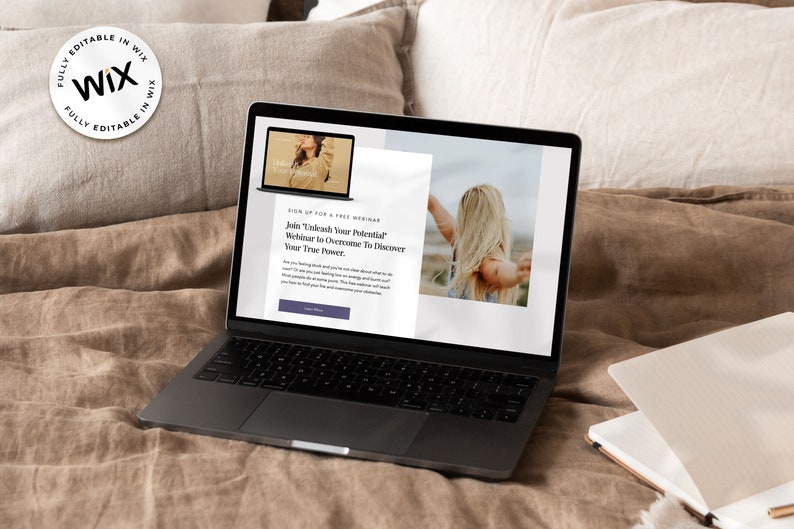 May include: A laptop computer on a bed with a brown blanket. The laptop screen shows a webpage with the text "Join 'Unleash Your Potential' Webinar to Overcome To Discover Your True Power."