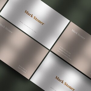 May include: Four business cards with a light brown and white background. The cards feature the name "Mark Stoner" in a brown font and contact information in a white font. The text on the cards includes a phone number, email address, and website address. The cards are arranged in a grid pattern.