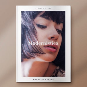 May include: A magazine cover mockup with a white background and the text "Modernistica" in a simple, clean font. The cover features a close-up photo of a woman with dark hair and a neutral expression.