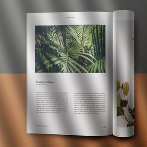 May include: Open magazine with a green tropical plant on the left page and a smaller green plant on the right page. The text on the left page reads "Modern Vibes".