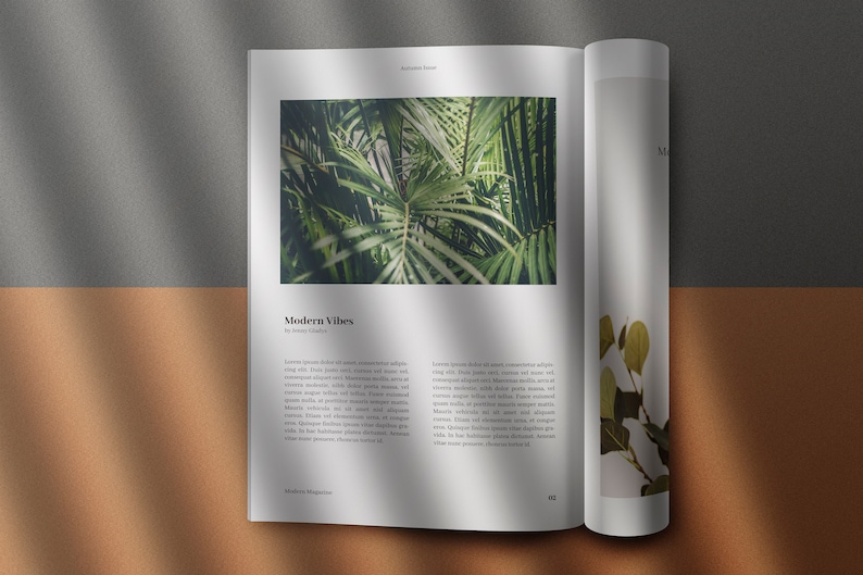 May include: Open magazine with a green tropical plant on the left page and a smaller green plant on the right page. The text on the left page reads "Modern Vibes".