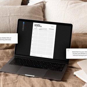 May include: A laptop computer displaying a printable worksheet titled "Everyday Mindfulness". The worksheet is divided into a grid with columns for "Date", "Time", "Activity", "Thoughts", "Feelings", and "Gratitude". The laptop is on a brown linen bedspread.