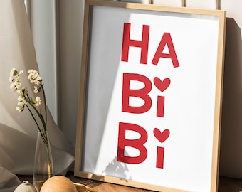 May include: A framed print with the words "Happy Birthday" in red letters with a small red heart between the "B" and "i" in each word.