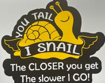 May include: A black and yellow snail decal with the text "You tail I snail The closer you get The slower I go!"