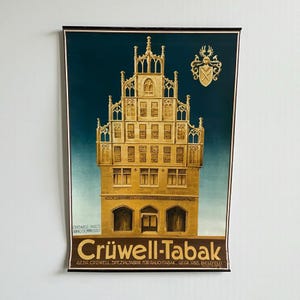 Può includere: Poster pubblicitario vintage per Crüwell-Tabak, con un'illustrazione dettagliata di un edificio storico. L'opera d'arte è ambientata su uno sfondo blu scuro, con l'edificio reso in tonalità oro e marrone. Il testo "Crüwell-Tabak" è visualizzato in basso.