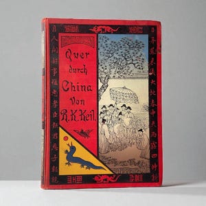 May include: Vintage book titled "Quer durch China" by R.K. Keil. The cover is red with Chinese characters and illustrations of people under a parasol and a blue bird. The book's title is in German.