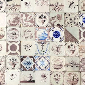 Puede incluir: Una colección de azulejos de cerámica antiguos con varios diseños pintados a mano. Los azulejos presentan patrones florales, veleros y escenas arquitectónicas en tonos azules, marrones y blancos. Cada azulejo mide aproximadamente 15 cm por 15 cm.