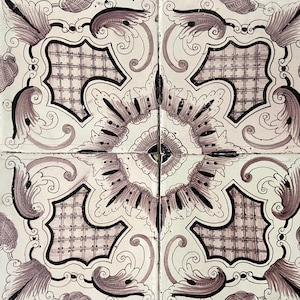 May include: Four square tiles arranged to form a larger square. Each tile features a white background with a repeating pattern of dark purple and black floral and geometric designs. The tiles have a vintage, decorative aesthetic.