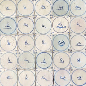 May include: A collection of square, off-white tiles with blue and white circular designs. Each tile features a different animal illustration in blue, including deer, rabbits, and squirrels. The tiles are arranged in a grid pattern.