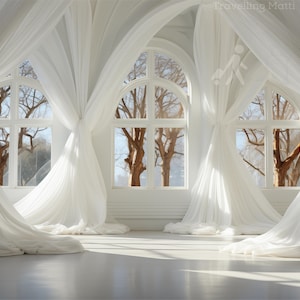 May include: A bright, airy interior with large arched windows draped with flowing white curtains. Sunlight streams through the windows, illuminating the room and highlighting the bare tree branches visible outside. The floor is a light, reflective surface.