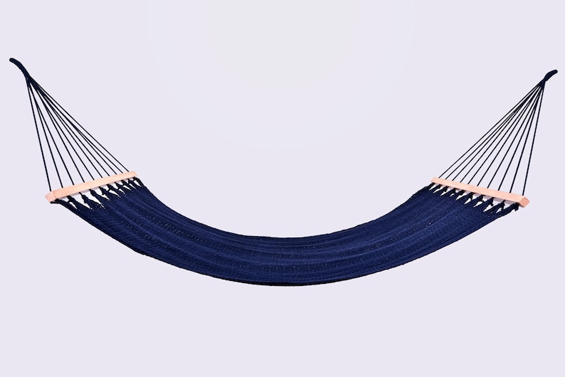 May include: A navy blue hammock with wooden spreader bars. The hammock is hanging from two ropes.