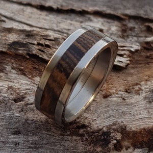 Titanium wedding ring. Set with Zebra wood.