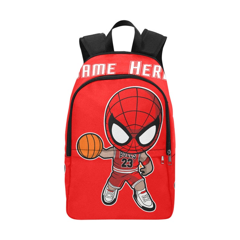 May include: Red backpack with a cartoon image of Spiderman playing basketball. The backpack has black straps and a zipper. The text "NAME HERE" is printed on the front of the backpack.