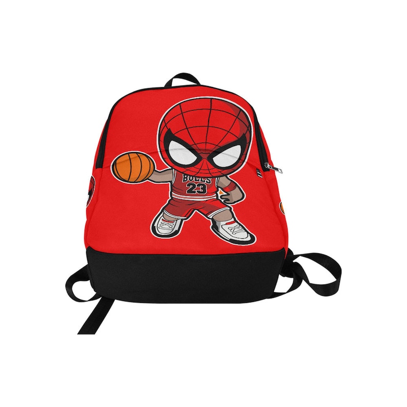 May include: Red backpack with a cartoon image of Spiderman playing basketball. The Spiderman character is wearing a red and black basketball uniform with the number 23 and the word "Bulls" on the front. The backpack has a black bottom and a zippered pocket on the front.