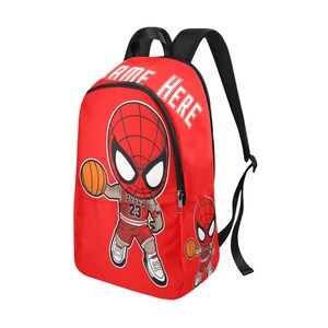 May include: Red backpack with a cartoon image of Spiderman playing basketball. The backpack has the text "NAME HERE" printed on the front.