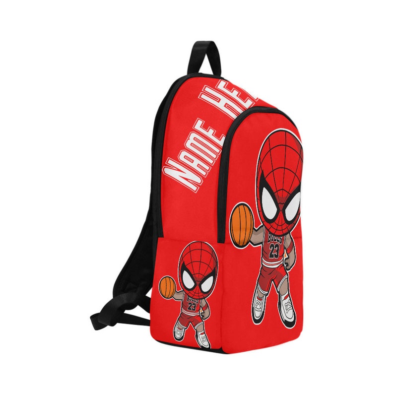 May include: Red backpack with a black zipper and straps. The backpack features a cartoon image of Spider-Man playing basketball. The text "NAME HERE" is printed on the front of the backpack.
