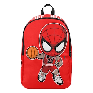 May include: Red backpack with a cartoon image of Spider-Man wearing a red and white basketball jersey with the number 23 and the word "BULLS" on the front. Spider-Man is holding a basketball and is wearing red and white sneakers.