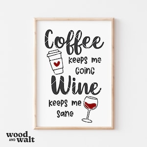 May include: A framed print with the text "Coffee keeps me going Wine keeps me sane." The design includes a coffee cup with a heart and a wine glass filled with red liquid. The frame is light brown.