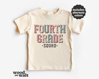 May include: A beige short-sleeved t-shirt with the text "FOURTH GRADE SQUAD" in a retro font with pink, green, and blue accents.