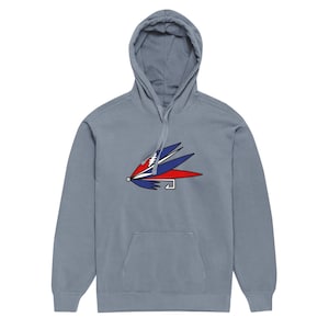 May include: A blue-grey hooded sweatshirt with a front pocket and a drawstring hood. The sweatshirt features a colorful graphic of a fishing lure in red, white, and blue.