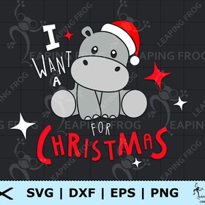 May include: A grey cartoon hippopotamus wearing a red Santa hat and sitting on a black background. The text "I want a for Christmas" is written in red letters around the hippo.