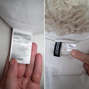 May include: Two close-up shots of a white garment. One shows a tag with washing instructions and fabric composition details, including '100% polyester'. The other shows a tag with the brand 'Divided' and size information. The garment appears to have a fluffy, light-colored trim.